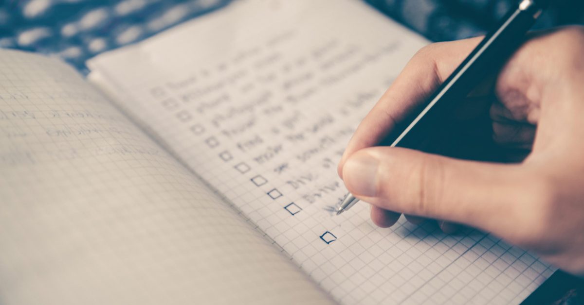 close up of a person writing in a journal