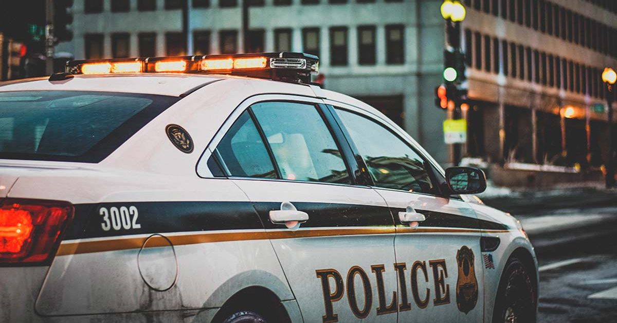 police car monitoring city streets